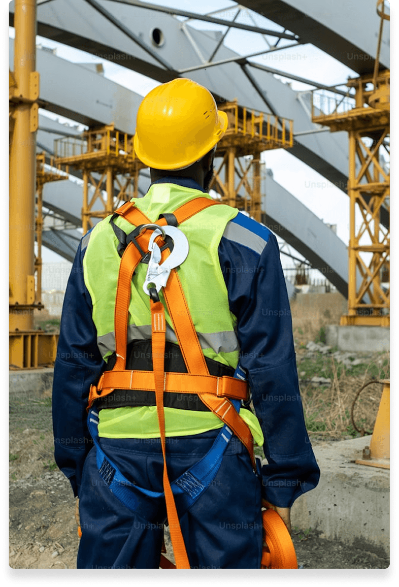 Construction worker in safety gear at an industrial site